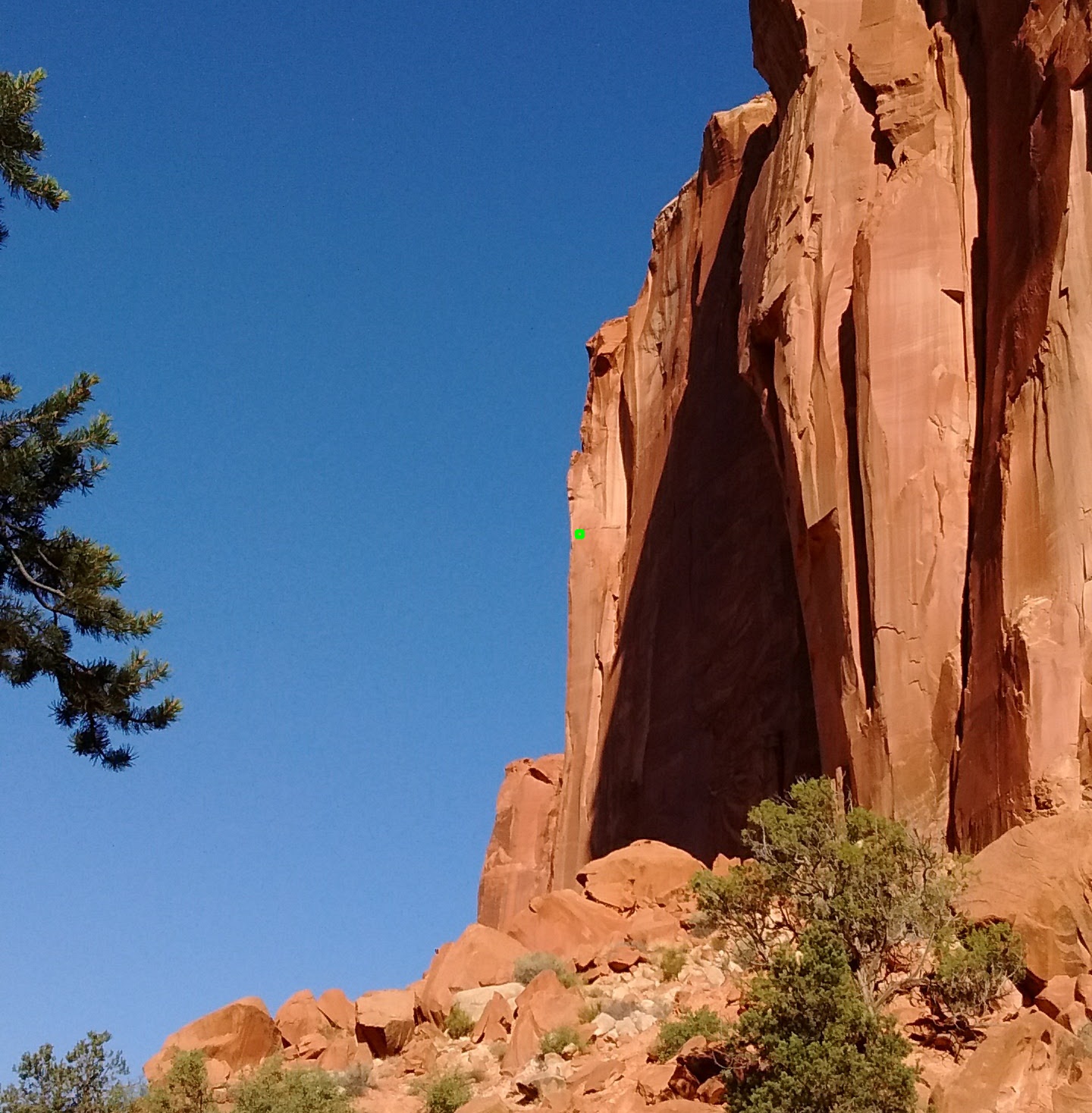 The photograph of the desert canyon wall with an eight by eight block of pixels highlighted.